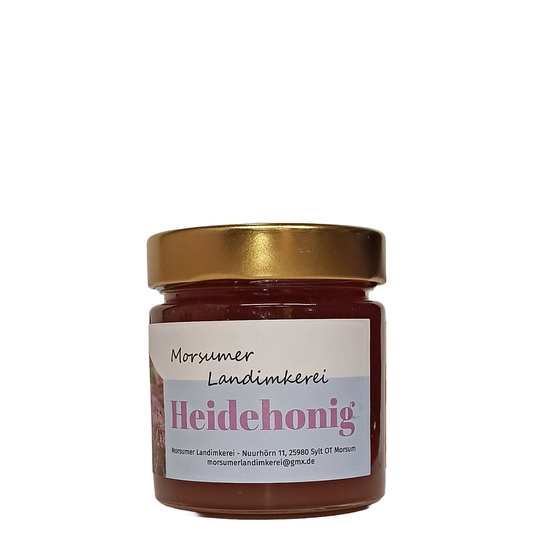 Honigglas Morsumer Landimkerei Heidehonig in runder Glasform mit goldenem Deckel und einem weiß-blauen Etikett mit der Aufschrift Heidehonig.